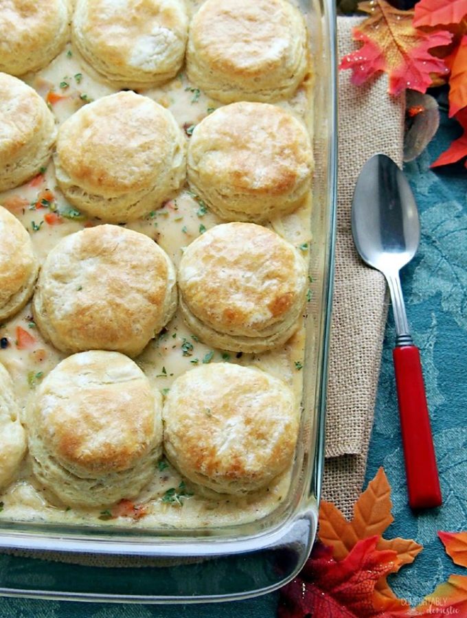 Casserole dish with golden biscuits with turkey pot pie filling underneath.