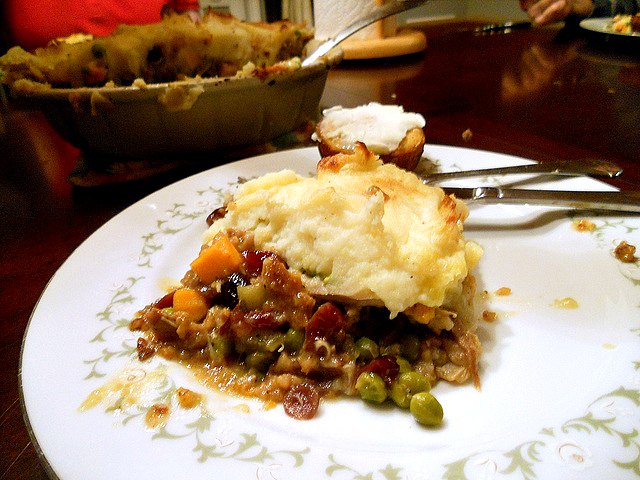 Thanksgiving leftovers shepherd's pie on a white plate. 